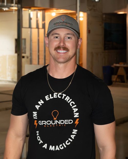 Grounded Electric electrician smiling on site