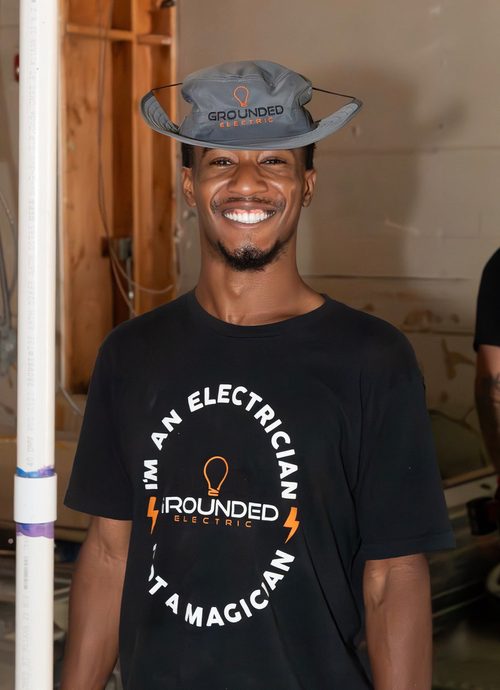Grounded Electric crew member in a hat